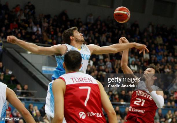 Sertac Sanli and Metin Turen of Turkey in action against Vyacheslav Kravtsov of Ukraine during the FIBA Basketball World Cup 2019 group B qualifying...
