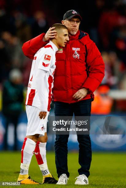Head coach Peter Stoeger of Koeln hughs Anas Ouahim after loosing the Bundesliga match between 1. FC Koeln and Hertha BSC at RheinEnergieStadion on...