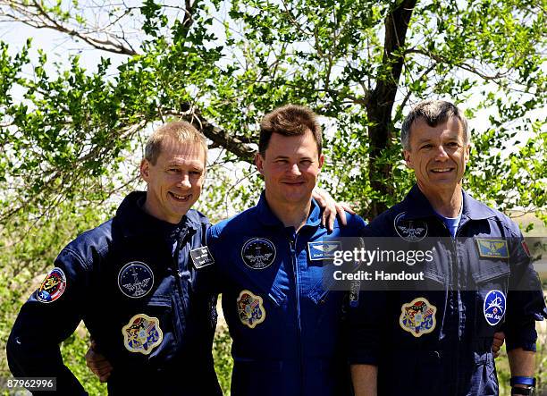 In this undated handout photo provided by the European Space Agency , The Soyuz TMA-15 crew, Frank De Winne, Roman Romanenko and Robert Thirsk take...