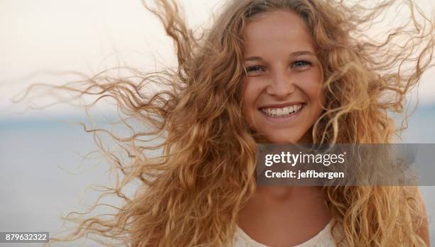 i love it when it's windy - curly blonde hair stock pictures, royalty-free photos & images