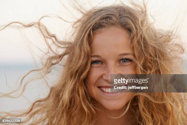 blown away by a beautiful fresh breeze - curly blonde hair stock pictures, royalty-free photos & images