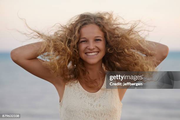 beautifully wild and windswept hair - hand in hair stock pictures, royalty-free photos & images