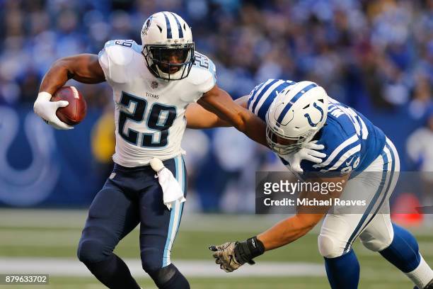 DeMarco Murray of the Tennessee Titans pushes off a tackle from Al Woods of the Indianapolis Colts during the first half at Lucas Oil Stadium on...