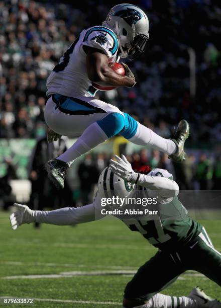Running back Fozzy Whittaker of the Carolina Panthers returns the kickoff against cornerback Darryl Roberts of the New York Jets during the first...