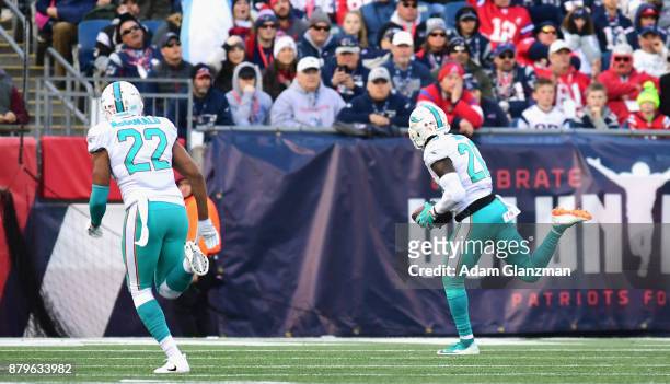 Reshad Jones of the Miami Dolphins carries the ball for a touchdown after a turnover during the second quarter of a game against the New England...