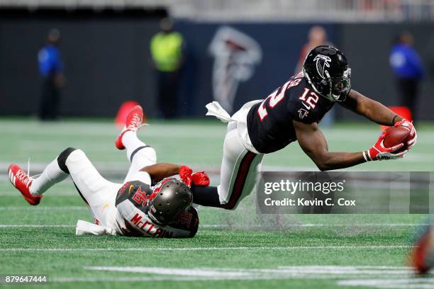 Mohamed Sanu of the Atlanta Falcons is tackled by Robert McClain of the Tampa Bay Buccaneers after a catch during the first half against the Tampa...