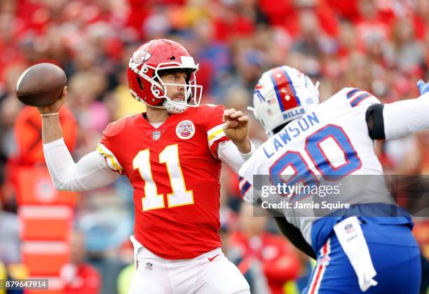 Quarterback Alex Smith of the Kansas City Chiefs passes as defensive end Shaq Lawson of the Buffalo Bills defends during the game at Arrowhead...