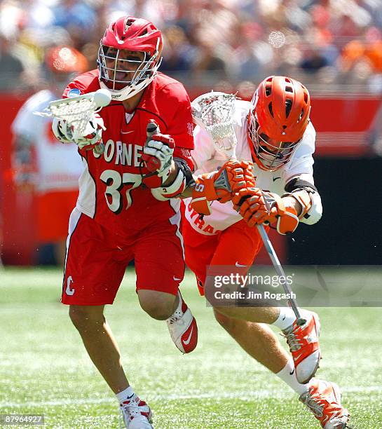 Rob Pannell of the Syracuse Orange presses Tyler Hlawati of the Cornell Big Red during the NCAA Division I Lacrosse Championship at Gillette Stadium...