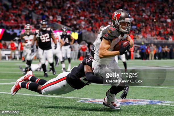 Adam Humphries of the Tampa Bay Buccaneers is tackled after a catch by Damontae Kazee of the Atlanta Falcons during the second half at Mercedes-Benz...