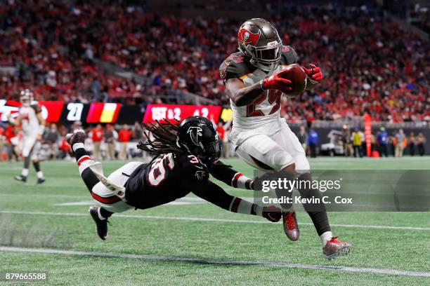 Peyton Barber of the Tampa Bay Buccaneers runs into the end zone for a touchdown past Kemal Ishmael of the Atlanta Falcons during the second half at...