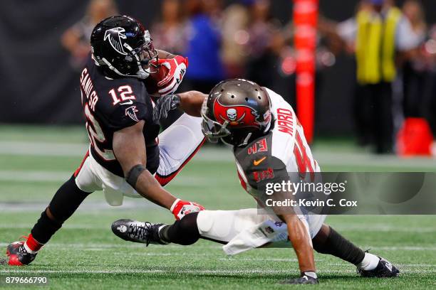 Mohamed Sanu of the Atlanta Falcons is tackled by T.J. Ward of the Tampa Bay Buccaneers after a catch during the second half at Mercedes-Benz Stadium...