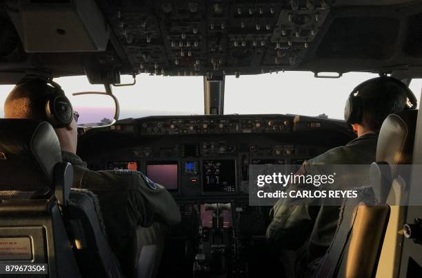 Members of the U.S. Navy Patrol and Reconnaissance Wing 11 fly on a P8-A Poseidon aircraft assisting the Argentine military in their search for the...