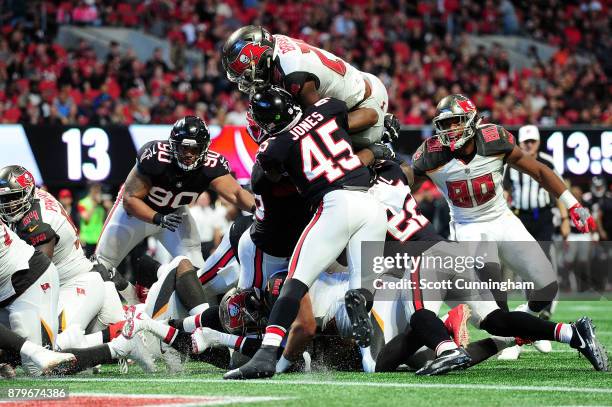 Peyton Barber of the Tampa Bay Buccaneers jumps over the pile to score a touchdown during the second half against the Atlanta Falcons at...