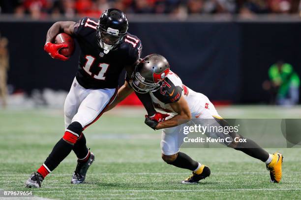 Julio Jones of the Atlanta Falcons is tackled by Brent Grimes of the Tampa Bay Buccaneers during the second half at Mercedes-Benz Stadium on November...