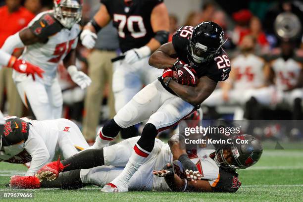 Tevin Coleman of the Atlanta Falcons is tackled by Gerald McCoy of the Tampa Bay Buccaneers during the second half at Mercedes-Benz Stadium on...