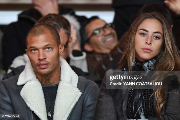 Model Jeremy Meeks and his companion, British heiress Chloe Green look on prior to the French L1 football match between Monaco and Paris...