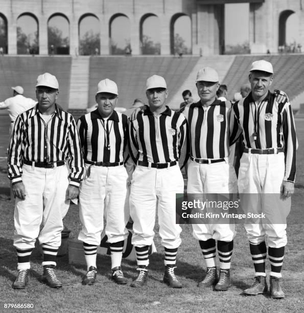 1950s, a group of NFL match officials pose prior to a game at the Los Angeles Colliseum.