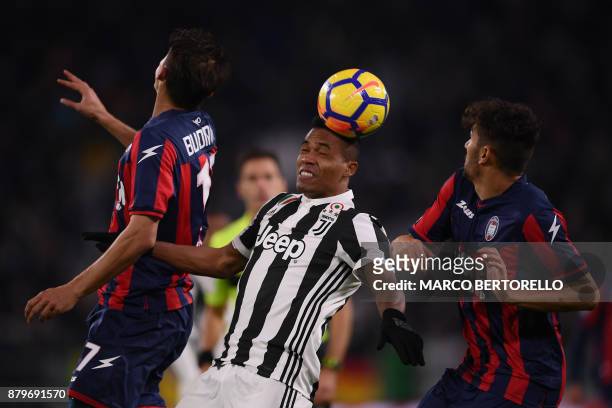 Juventus' defender Alex Sandro from Brazil heads the ball next to Crotone's forward Ante Budimir from Croatia during the Italian Serie A football...