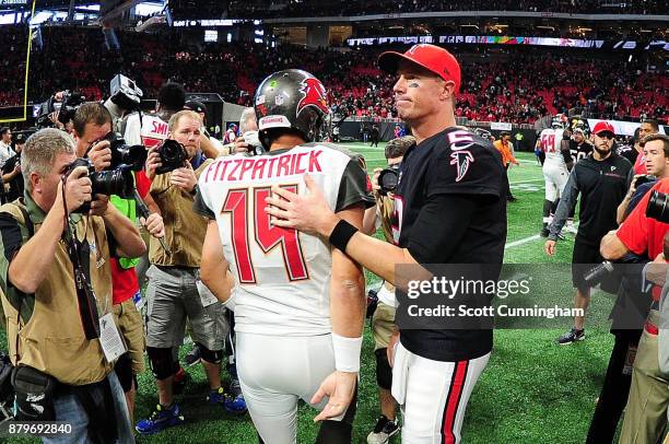 Matt Ryan of the Atlanta Falcons pats Ryan Fitzpatrick of the Tampa Bay Buccaneers on the back after the game at Mercedes-Benz Stadium on November...