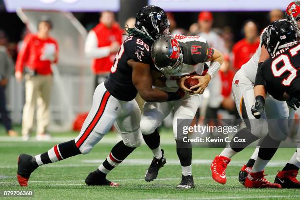 Ryan Fitzpatrick of the Tampa Bay Buccaneers is sacked by Takkarist McKinley of the Atlanta Falcons during the second half at Mercedes-Benz Stadium...