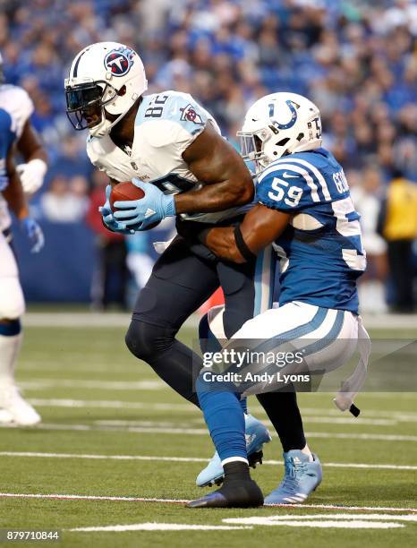 Delanie Walker of the Tennessee Titans runs with the ball while defended by Jeremiah George of the Indianapolis Colts at Lucas Oil Stadium on...
