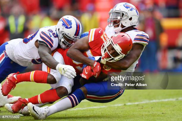 Running back Akeem Hunt of the Kansas City Chiefs is tackled by Ramon Humber and teammate defensive end Jerry Hughes of the Buffalo Bills during the...