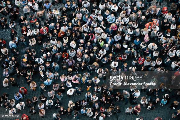 high angle view of a crowded square - menschenmenge stock-fotos und bilder
