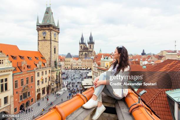 happy tourist looking at the old town square from above, prague, czech republic - stare mesto stock-fotos und bilder