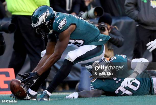 Jay Ajayi of the Philadelphia Eagles fumbles the ball in the endzone as teammate Nelson Agholor recovers for the touchdown in the fourth quarter...