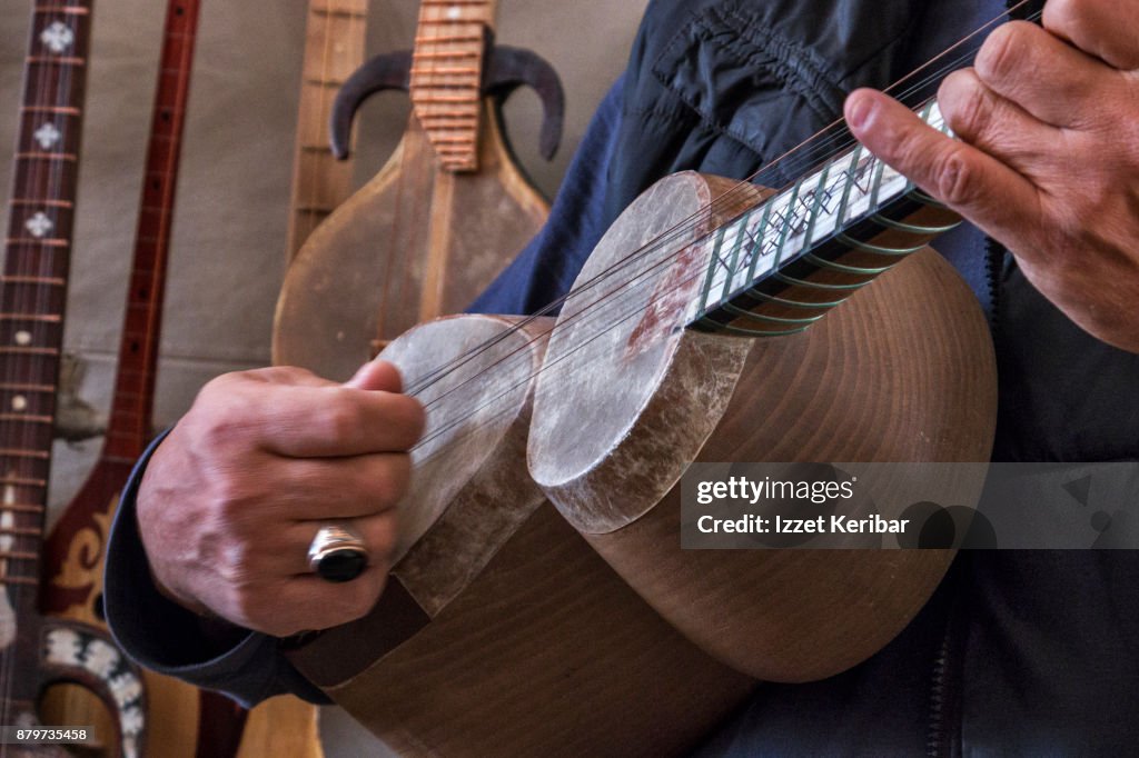 Man Playing A Traditional String Instrument Called Tar At Bukhara ...