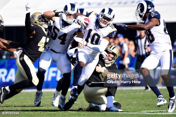 Wil Lutz of the New Orleans Saints tackles Pharoh Cooper of the Los Angeles Rams on the opening kickoff during the first quarter of the game at the...