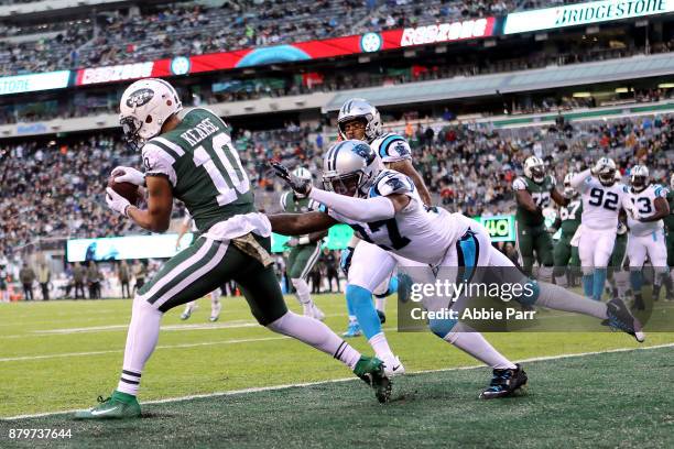 Jermaine Kearse completes a three yard touchdown pass from Josh McCown of the New York Jets against Kevon Seymour of the Carolina Panthers in the...