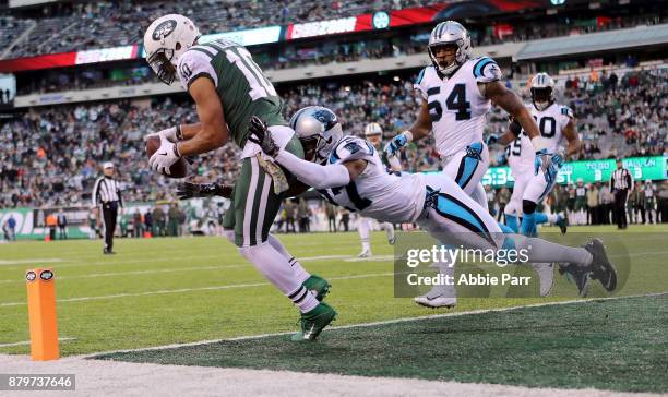 Jermaine Kearse completes a three yard touchdown pass from Josh McCown of the New York Jets against Kevon Seymour of the Carolina Panthers in the...