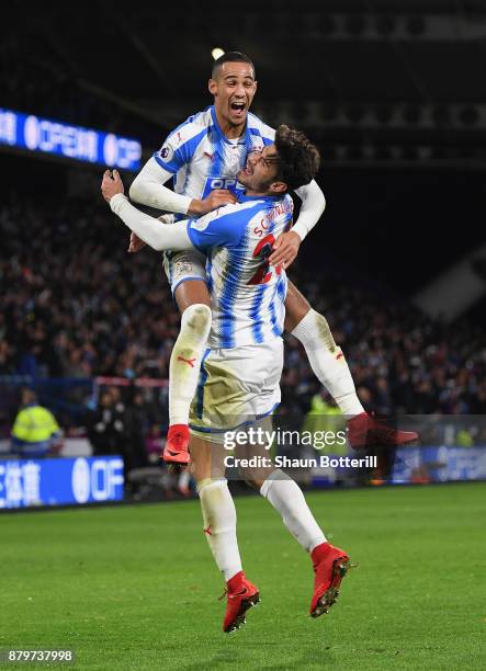 Tom Ince and Christopher Schindler of Huddersfield Town celebrate after Nicolas Otamendi of Manchester City scored the an own goal during the Premier...