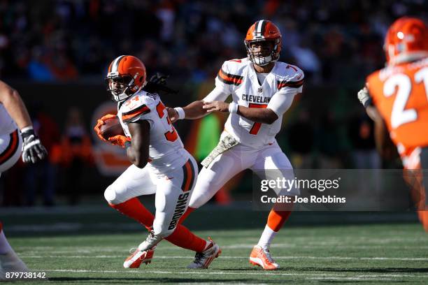 DeShone Kizer of the Cleveland Browns hands of to Isaiah Crowell in the first half of a game against the Cincinnati Bengals at Paul Brown Stadium on...