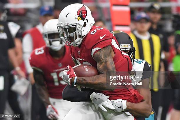 Ricky Seals-Jones of the Arizona Cardinals carries the football against Barry Church of the Jacksonville Jaguars in the first half at University of...