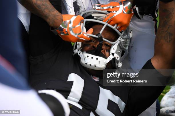Michael Crabtree of the Oakland Raiders has his helmet pulled off during a fight with Aqib Talib of the Denver Broncos in their NFL game at...