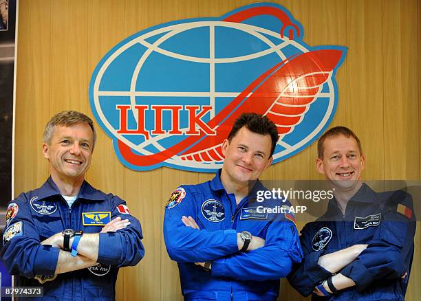 European Space Agency astronaut Frank De Winne of Belgium , Canadian astronaut Robert Thirsk and Russian cosmonaut Roman Romanenko pose during a...