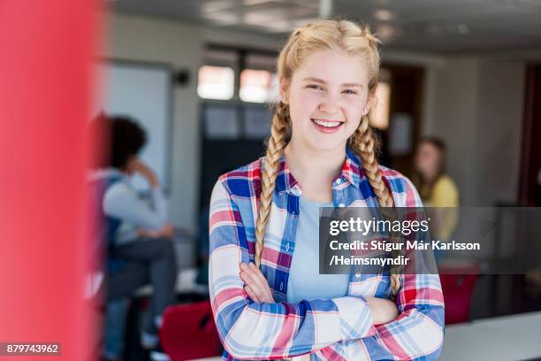 smiling blond teenage girl with arms crossed - open day 14 stock pictures, royalty-free photos & images