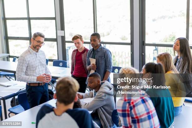 multi-ethnic students discussing with professor - classroom discussion stock pictures, royalty-free photos & images