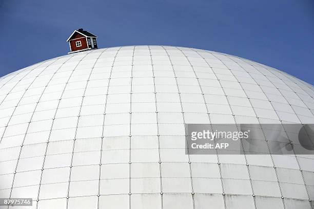 Red cottage designed by Swedish artist Mikael Genberg sits atop the Ericsson Globe Arena, where it will remain for the summer, on May 26, 2009 in...