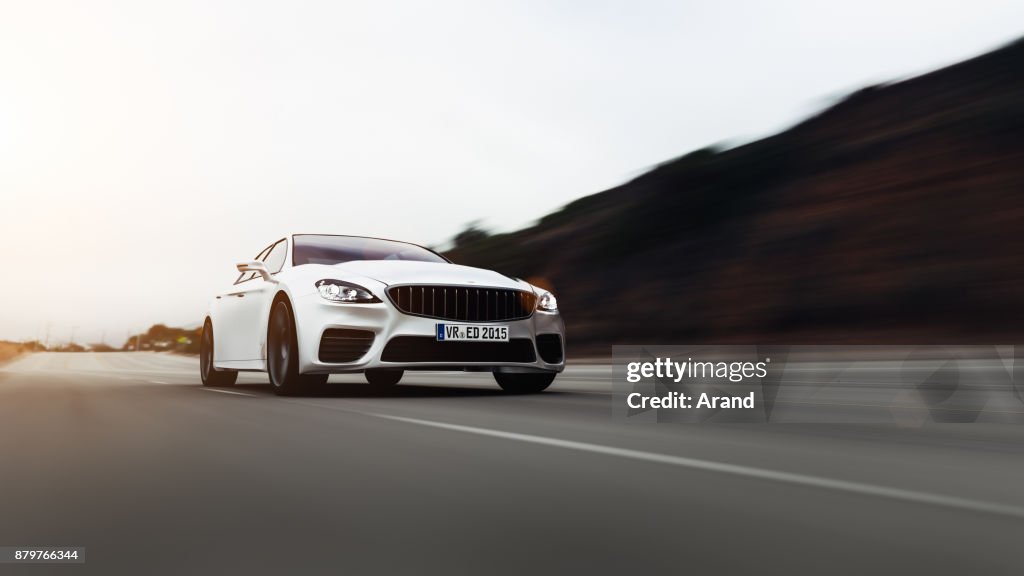 Car driving on a road by sea