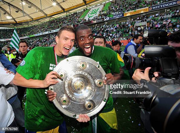 Edin Dzeko and Grafite of Wolfsburg celebrate the German championship with the trophy after their Bundesliga match against SV Werder Bremen on May...