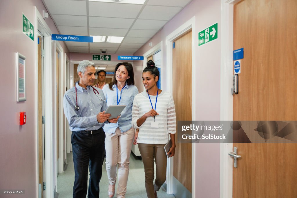 Three Doctors Walking Down the Corridor