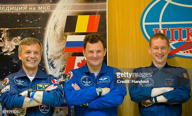 In this handout photo provided by the European Space Agency , The Soyuz TMA-15 crew, Robert Thirsk, Roman Romanenko and Frank De Winne attend a press...