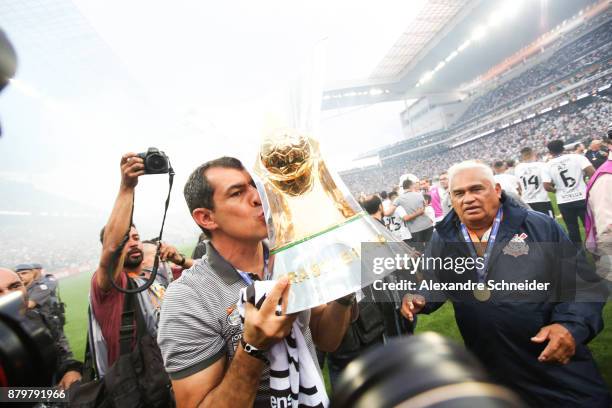 Fabio Carille of Corinthians celebrates with the trophy after Corinthians win the Brasileirao 2017 after the match against Atletico MG for the...