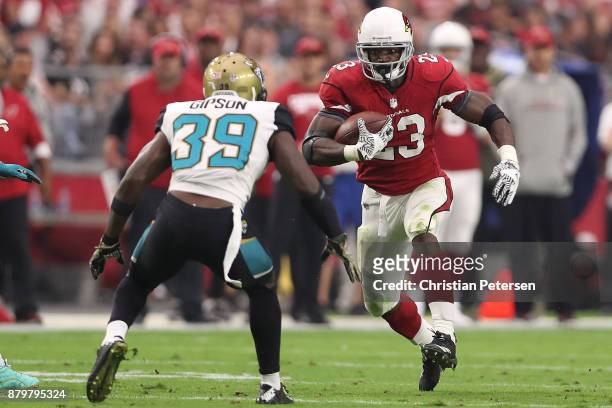 Adrian Peterson of the Arizona Cardinals rushes the football in front of Tashaun Gipson of the Jacksonville Jaguars in the first half at University...