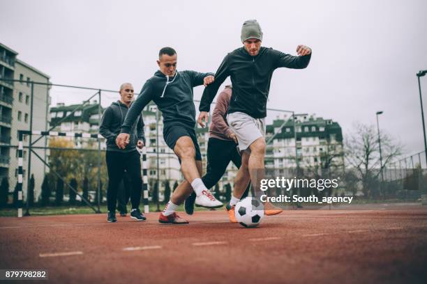 friends playing soccer - soccer dribbling stock pictures, royalty-free photos & images