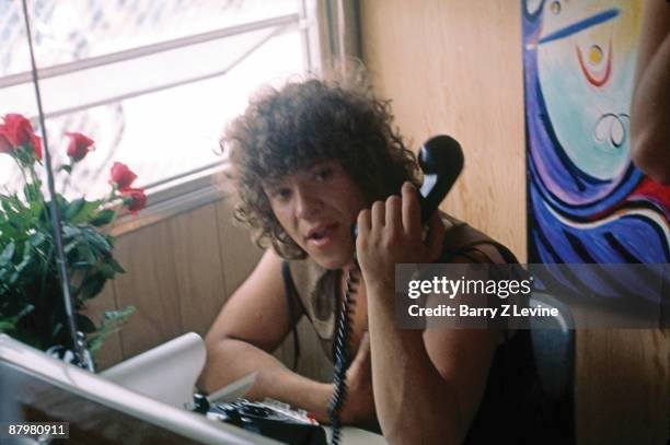 American concert producer & promoter Michael Lang holds a telephone in an office at the Woodstock Music and Arts Fair in Bethel, New York, August 15...