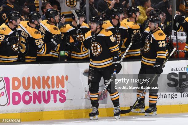 David Pastrnak and Patrice Bergeron of the Boston Bruins celebrate a first period goal against the Edmonton Oilers at the TD Garden on November 26,...